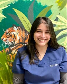 Picture of staff member smiling in front of zebra wall mural